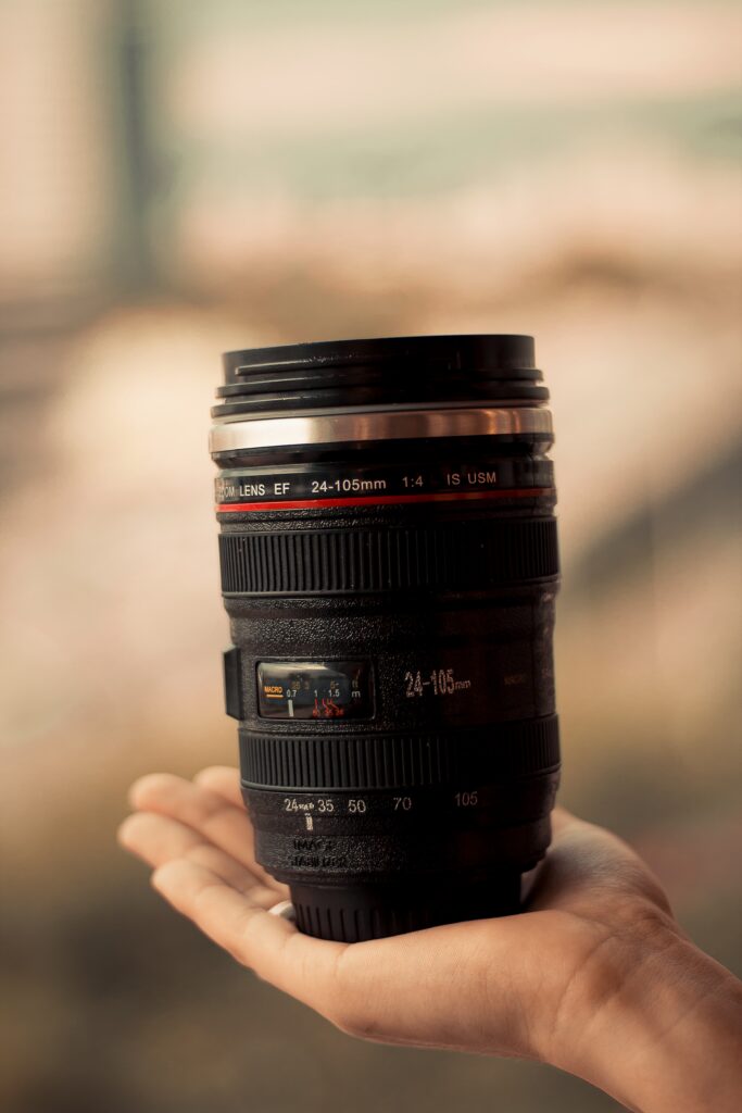 Hand holding a zoom camera lens