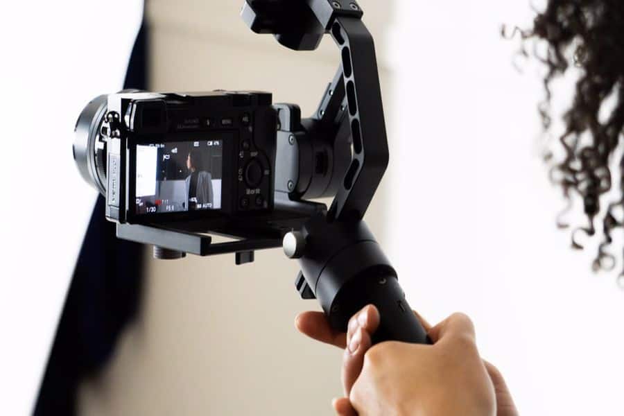 Hand holding a camera attached to a gimbal