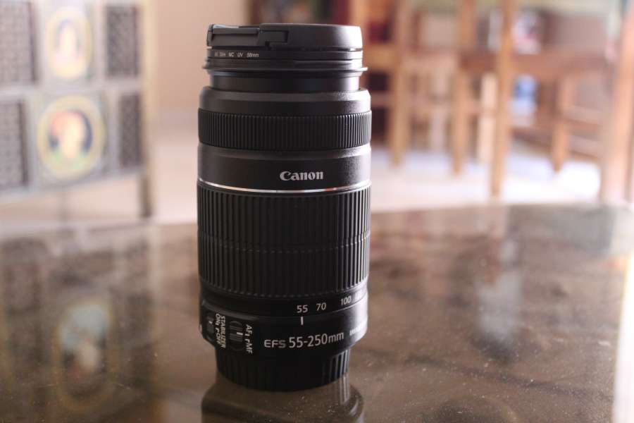 A Canon 55-250mm lens on a table