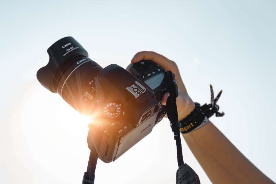 Hand holding a camera against sunlight