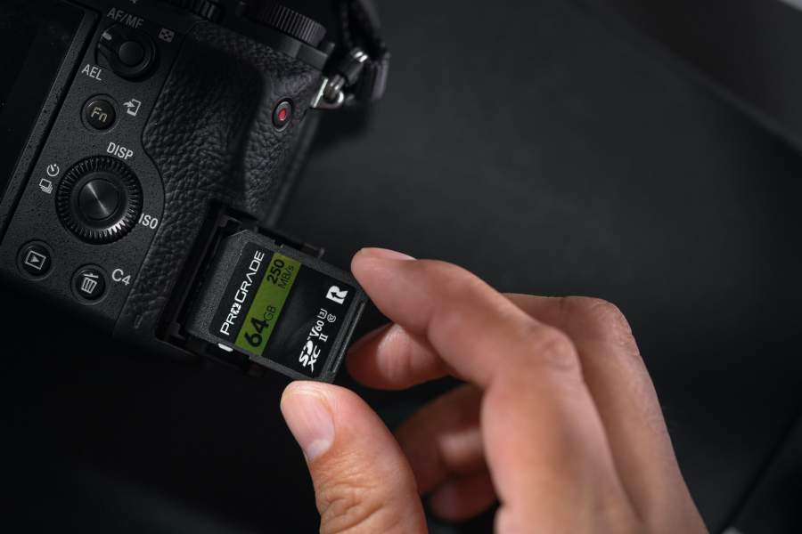 An SDXC card being inserted into a camera