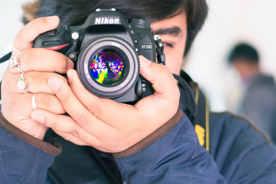 Man holding a Nikon camera