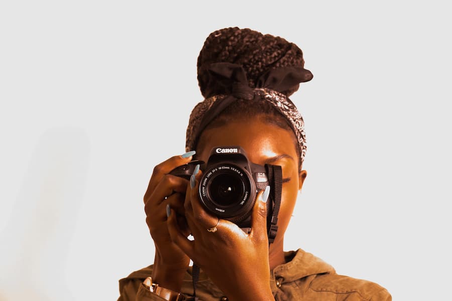 Woman holding an SL1 Canon camera